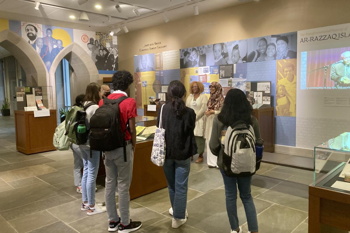 students looking at exhibit in library