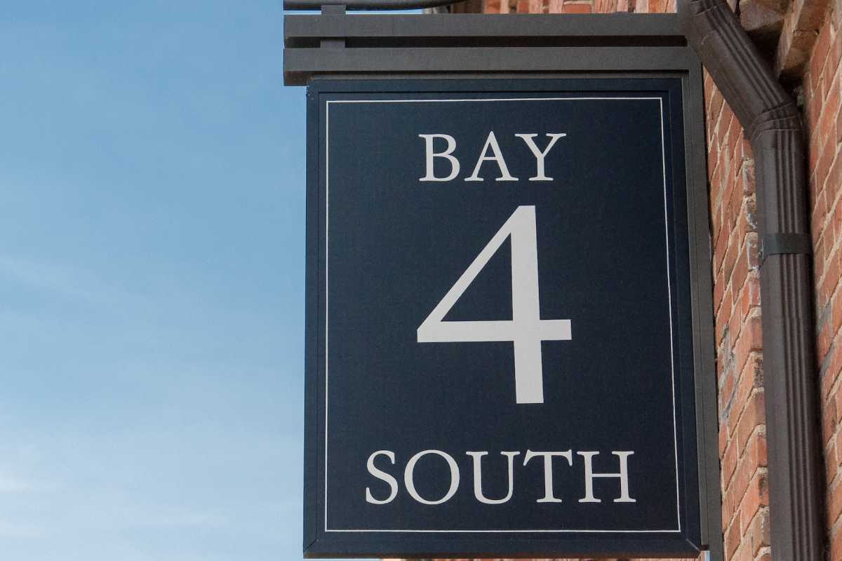 image of blue outdoor signing reading "Bay 4 South"