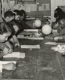 black and white photo of students doing schoolwork